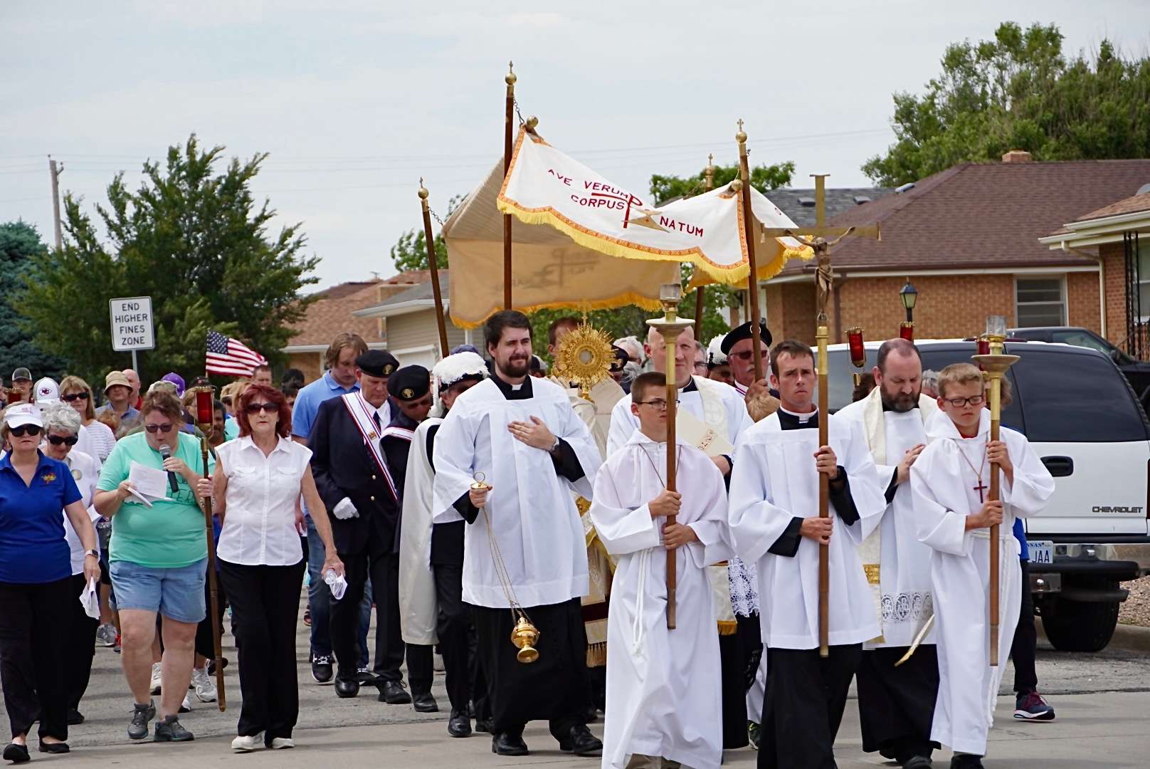 Clergy lead the Corpus Christi procession with parishioners from the Heartland Parishes of Ellis County.