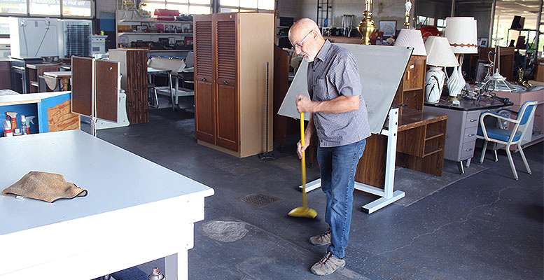 A volunteer at the Habitat for Humanity of Ellis County ReStore tidies up Wednesday in anticipation of the store reopening Saturday for the first time since it was shut down due to COVID-19 in March. Cristina Janney/Hays Post
