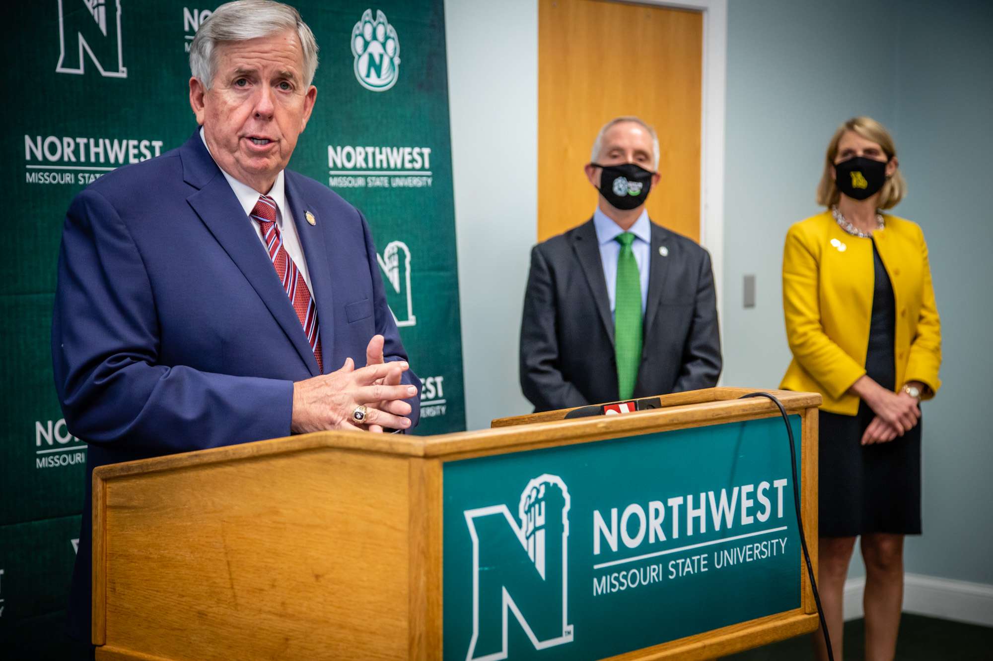 Gov. Mike Parson speaks as Northwest Missouri State University President John Jasinski and Missouri Western State University interim President Elizabeth Kennedy look on/Photo by Todd Weddle, Northwest Missouri State University