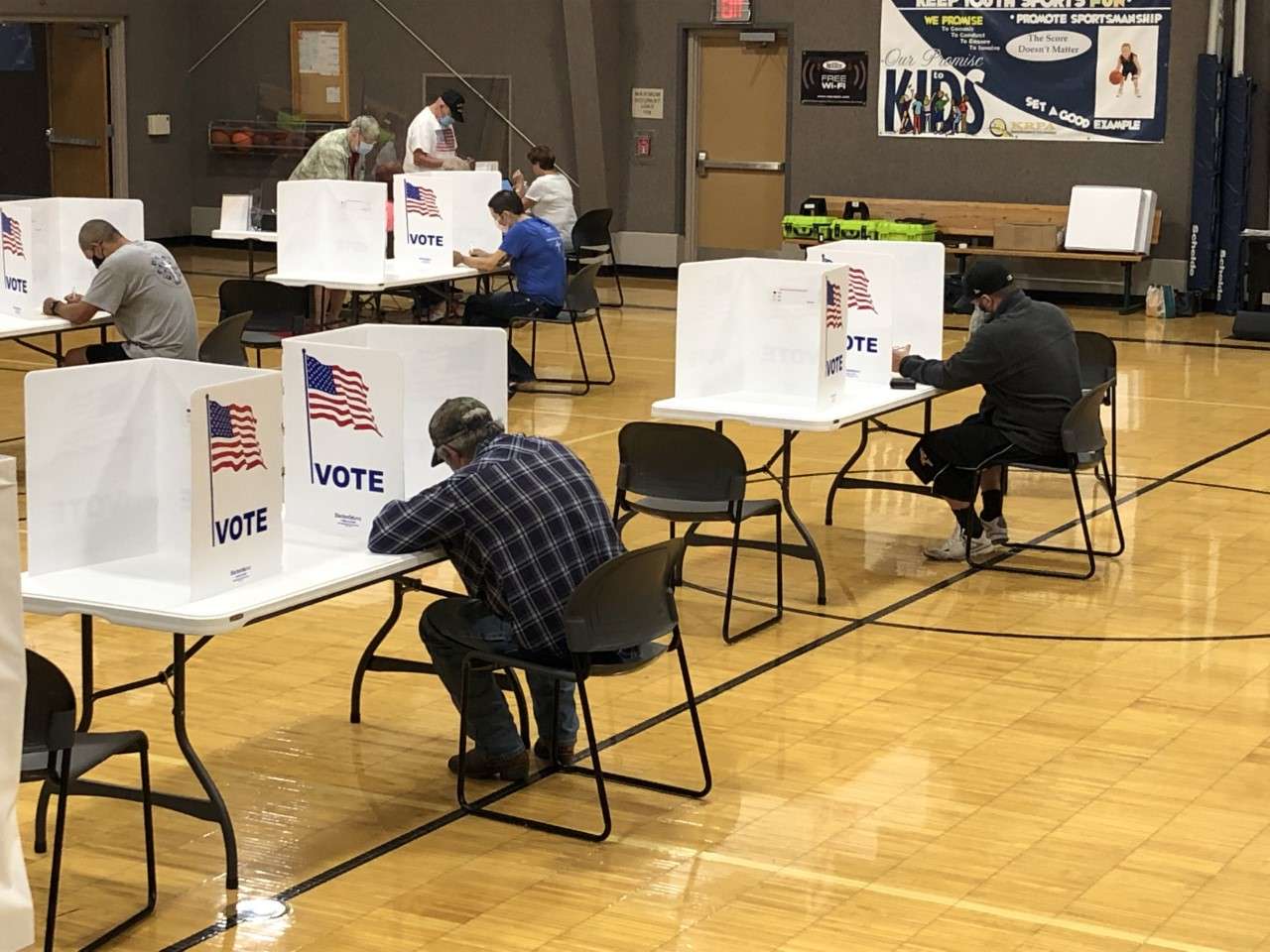 Voters are using pens provided by poll workers to mark their ballots in ink. The pens, which have an electronic stylus on the other end for signing their ballots, are kept by voters.