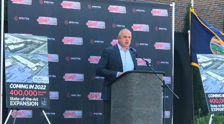 <b>Schwan's CEO Dimitrios Smyrnios talks of the expansion project during an announcement Monday afternoon outside Tony's Pizza Events Center.</b> Salina Post photos