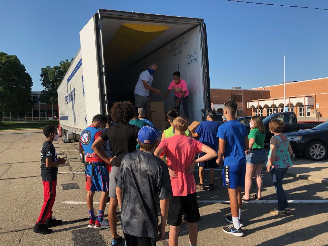 Volunteers helping unload food