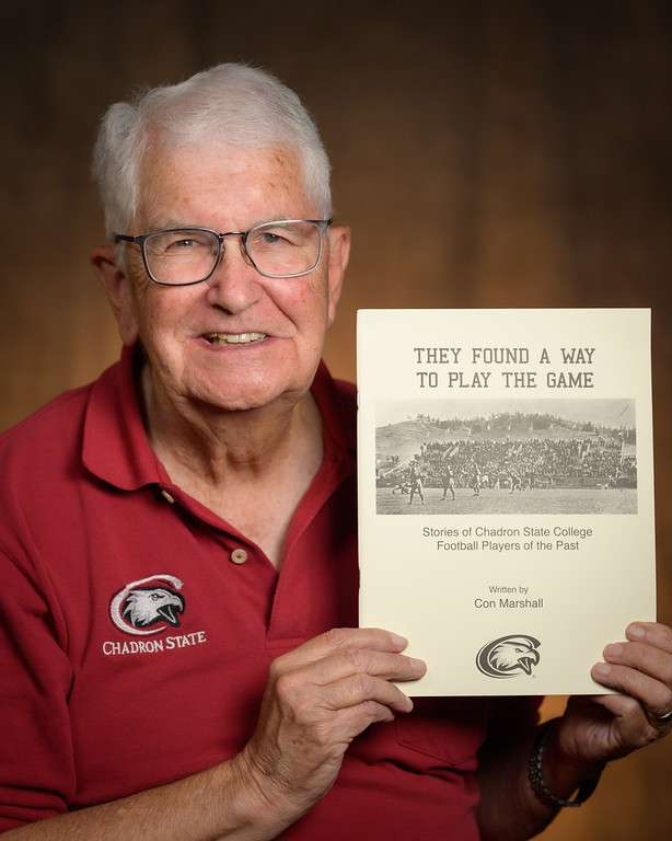 Con Marshall poses with his book "They Found a Way to Play the Game," a collection of stories about past Chadron State College football players. (Photo by Daniel Binkard/Chadron State College)