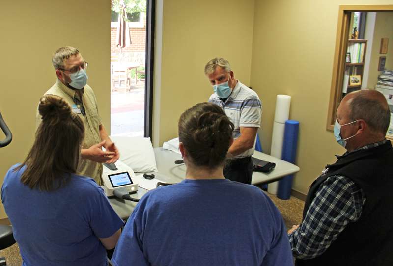 <i><b>Athletic Trainer Justin Clark (top left), from Memorial Health System (MHS) Rehabilitation and Sports Medicine, provides training to staff on the new Kelvi unit while Jeff Sanborn (top right), MHS Rehabilitation & Sports Medicine Director, assists.</b> Photo courtesy MHS</i>