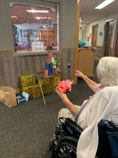 Henny Karlin plays a can toss game during the fair. Courtesy photo