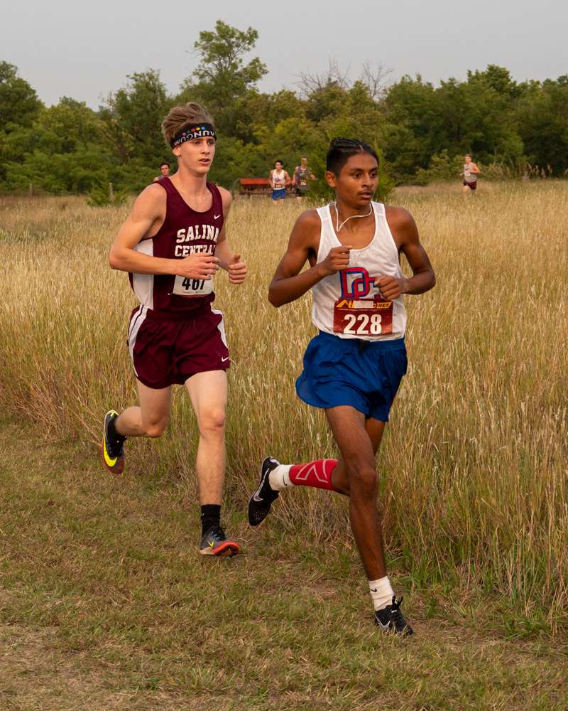 <b>Salina Central's William Griffith duels with a Dodge City runner during the Hays Invitational. Griffith went on to win the varsity meet.</b> Photos courtesy Danton McDiffett