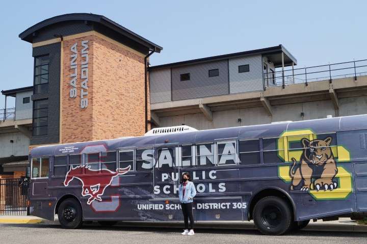 <b>Central's Karlyn Brecheisen stands in front of the USD 305 activity bus that is wrapped in her design.</b> Photos courtesy USD 305