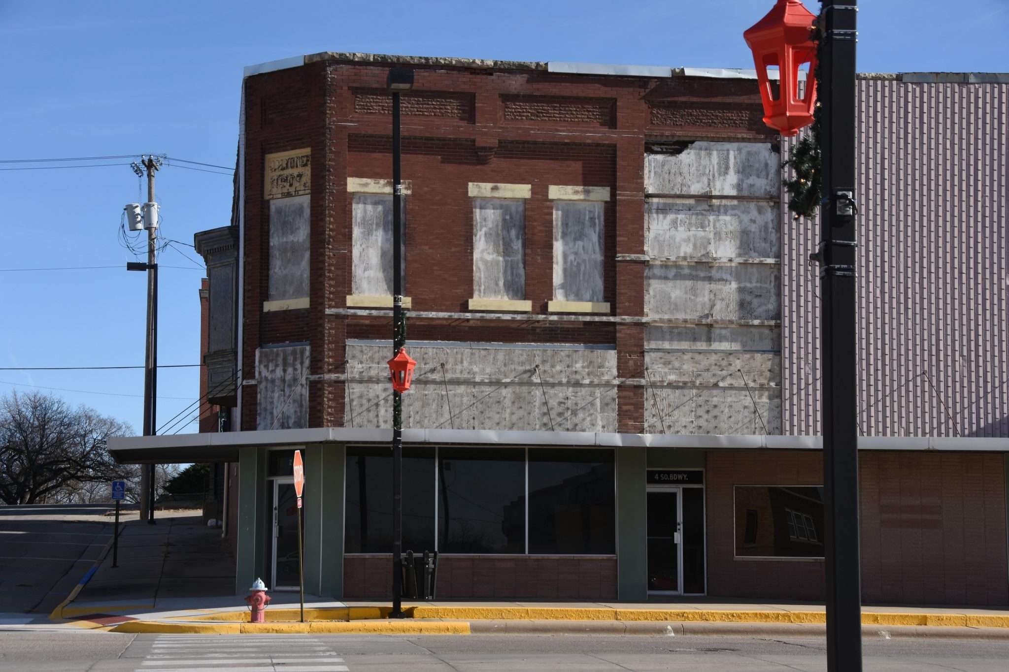 <b>The old pool hall in Herington has been closed for many years. On this block there was a bakery, a Western Auto, a newspaper office — all gone. Across the street, a strip mall was built but it's since been plowed under. </b>(Rebecca Otte)