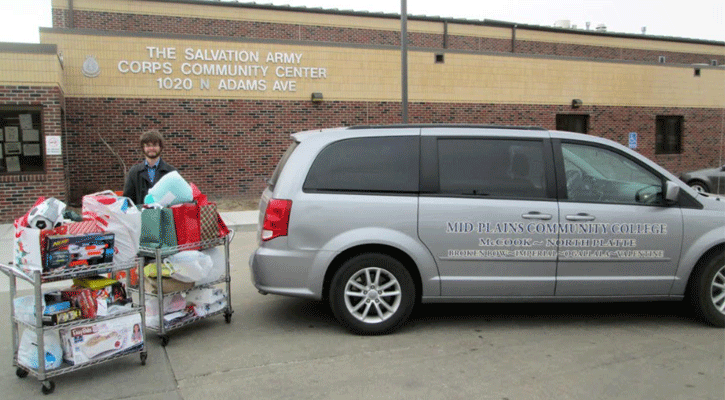 <i>North Platte Community College STEM Club member Packer Daily prepares to deliver donated Christmas gifts to The Salvation Army of North Platte. NPCC students and employees gave a record number of gifts to children in need over the holidays.</i>