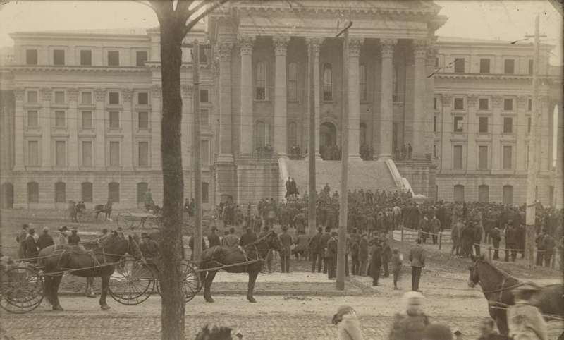 <b>The scene at the Kansas Statehouse in Topeka on Feb. 15, 1893. According to the Kansas State Historical Society, a mob gathered "after an attempt to disarm a member of the militia during the Populist War. This dispute began when both the Republican and Populist parties claimed victory in the Kansas House elections in 1892. A number of contests were still being disputed when the legislative session began in January 1893. The conflict between the parties reached a crisis when the Populists locked themselves in the House Hall. The Republicans used a sledgehammer to break down the doors to the hall." </b>(<a href="http://kansasmemory.org">kansasmemory.org</a>/Kansas State Historical Society)