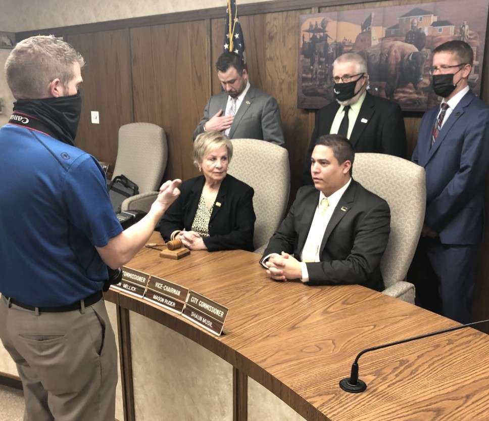 Sandy Jacobs was appointed mayor and Mason Ruder as vice-mayor during Thursday's reorganization of the Hays city commission. Brandon Cooley, Convention and Visitors Bureau videographer, aligns commissioners for their official portrait after the meeting.