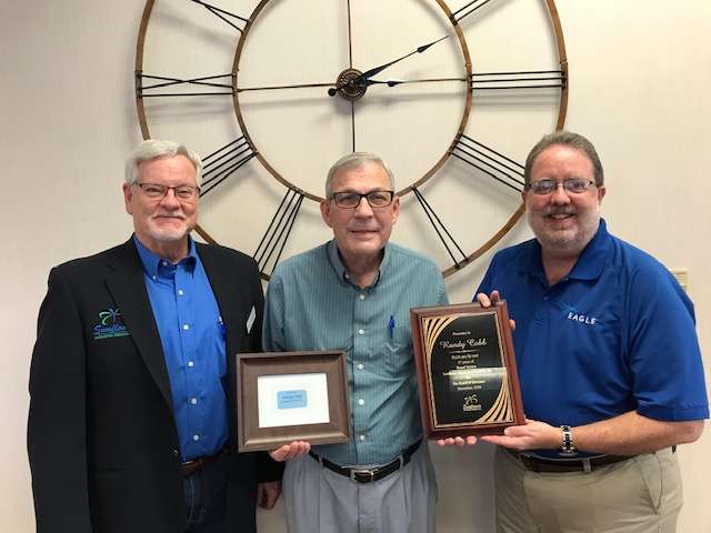 Randy Cobb, center, is recognized for his 17 years of serving on the Sunflower Diversified Services Board of Directors. Sunflower Chief Executive Officer Jon Prescott, left, and Board President Scott Donovan present Cobb with a plaque and lifetime pass to the non-profit agency’s Charity Gala.