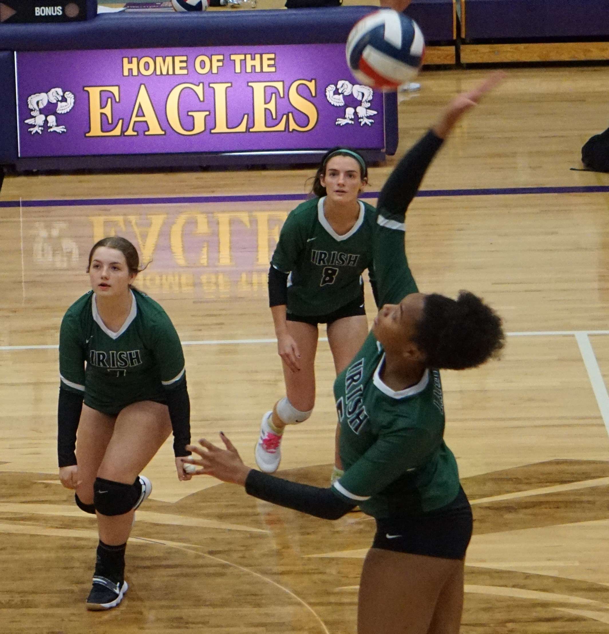 Khiani Jackson (right) hits a ball in the first set against Bishop LeBlond.