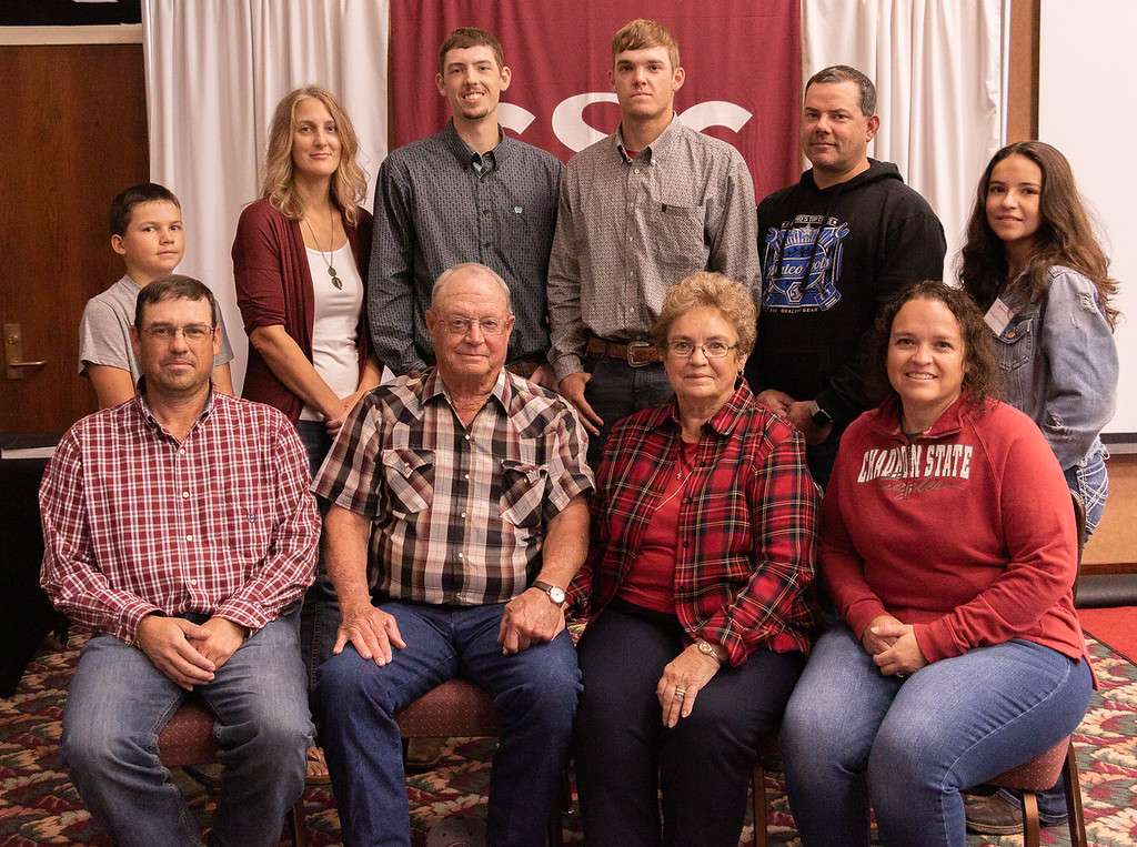The Burkhiser-Madsen family is recognized during Chadron State College Homecoming Oct. 9, 2021, in the Student Center. Back row, from left, Roudy Schommer, Carey Madsen, Clay Madsen, Cole Madsen, Marty Schommer, and Morgan Schommer. Front row, from left, Justin Madsen, John Madsen, Kim Madsen, and Julie Schommer.(Photo by Tena L. Cook/Chadron State College)