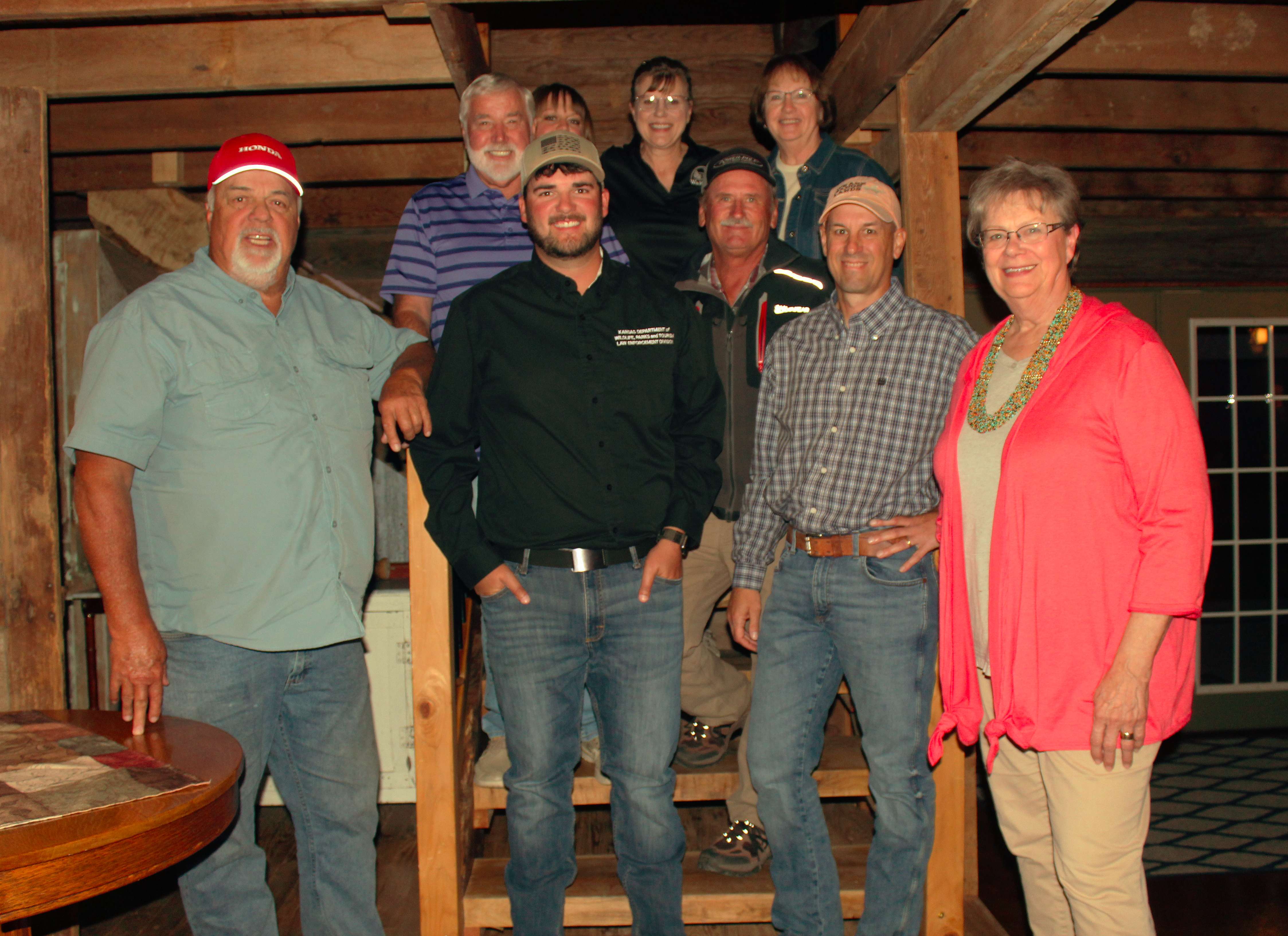 The hosts and crew from the Outdoor Channel's "Fishing University" met with members of the Wakeeney Travel and Tourism board on Sunday along with local game warden Matt Schmidt (center front row) at Shiloh Vineyard Sunday before several days of filming and fishing in the area.<br>