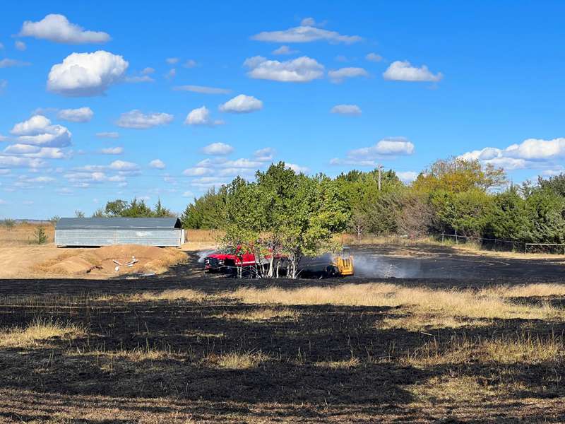 <b>Rural Fire District No. 6 firefighters extinguish a grass fire that burned a skid loader west of Salina.</b> Photo courtesy Saline County Sheriff's Office