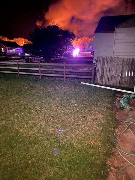 Russell emergency responders were called to a fully engulfed garage fire Sunday night at&nbsp; 1709 North Maple Street, which also burned a portion of the adjacent house. (Photos courtesy Russell Fire Department)