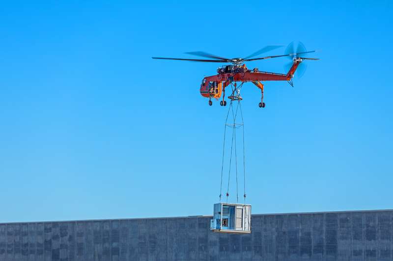 <b>A helicopter lifts an HVAC unit onto the roof of the Schwan's expansion.</b> Photos courtesy Schwan's