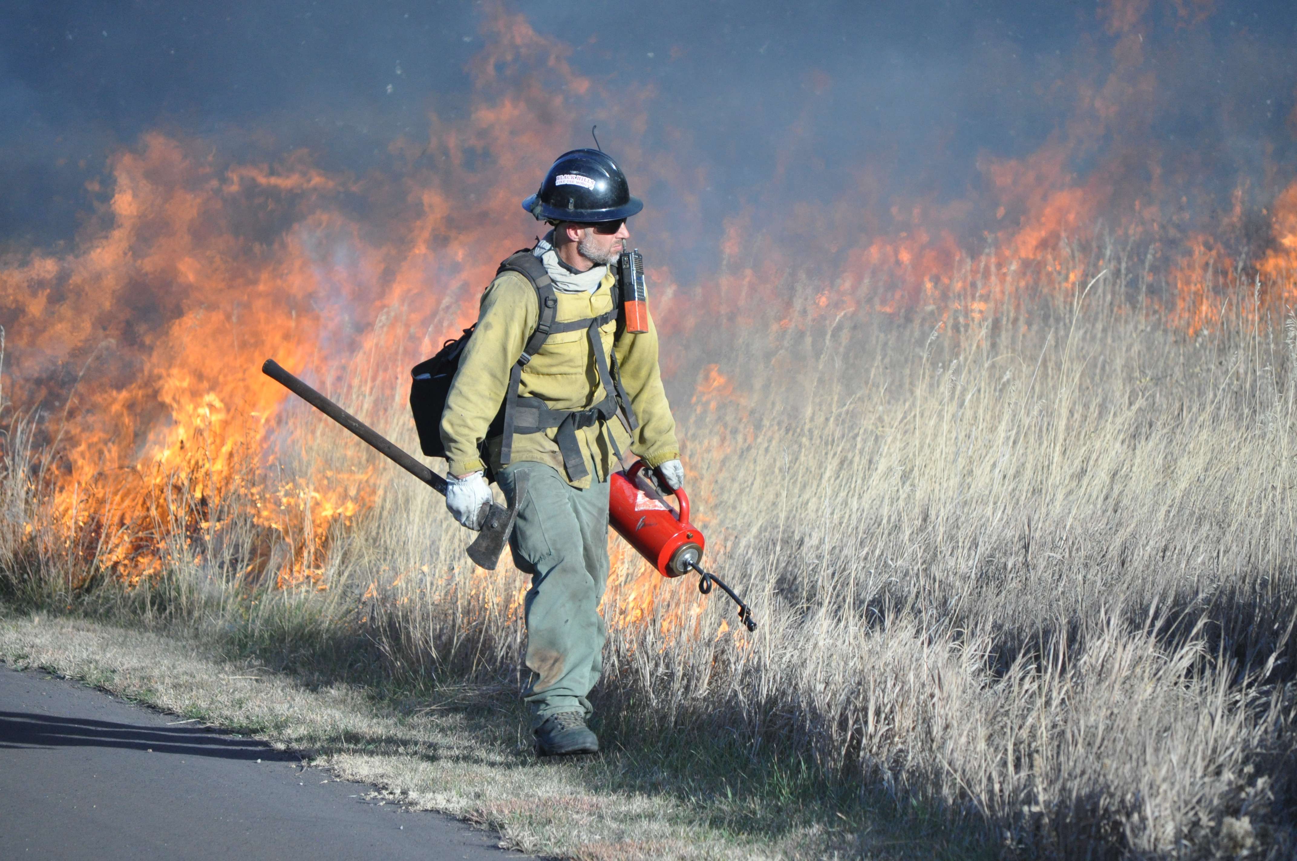 A firefighter uses a drip torch to help ignite the Headquarters East Fire. (NPS photo)