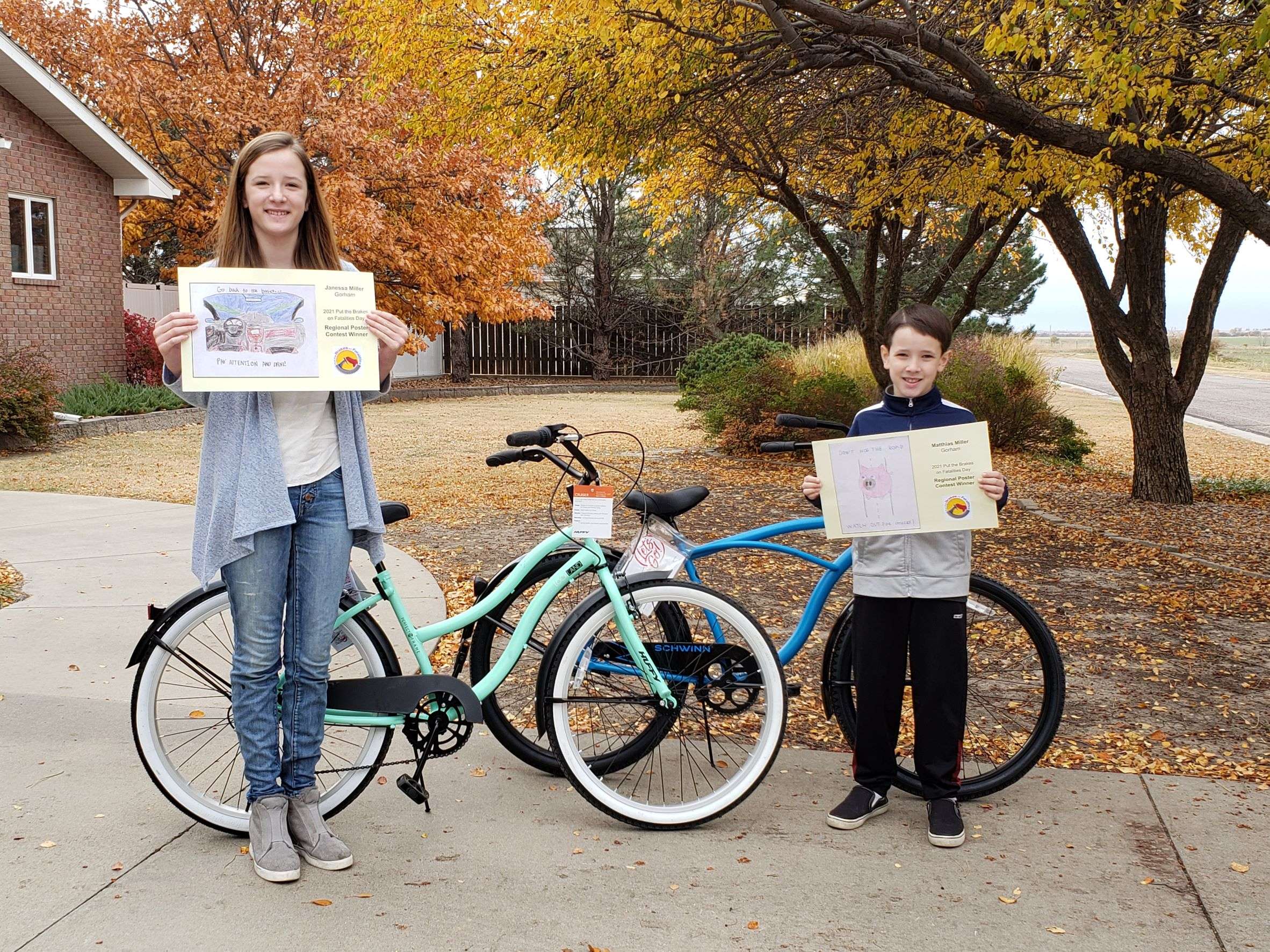 Janessa Miller , left, and Matthias Miller with their bikes received from KDOT’s Put the Brakes on Fatalities Day poster contest.