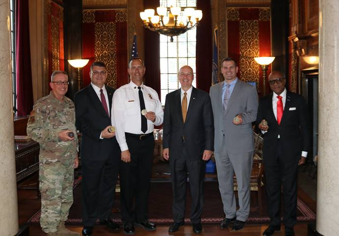 <i>Gov. Ricketts and members of his cabinet receiving their Nebraska Military challenge coins. From left to right, NE National Guard Adjutant General, Maj. General Daryl Bohac, Dept. of Veterans’ Affairs Director John Hilgert, State Fire Marshal Chris Cantrell, Gov. Ricketts, DAS Director Jason Jackson, and Dept. of Economic Development Director Tony Goins. Not pictured: Chief Medical Officer Dr. Gary Anthone.</i>