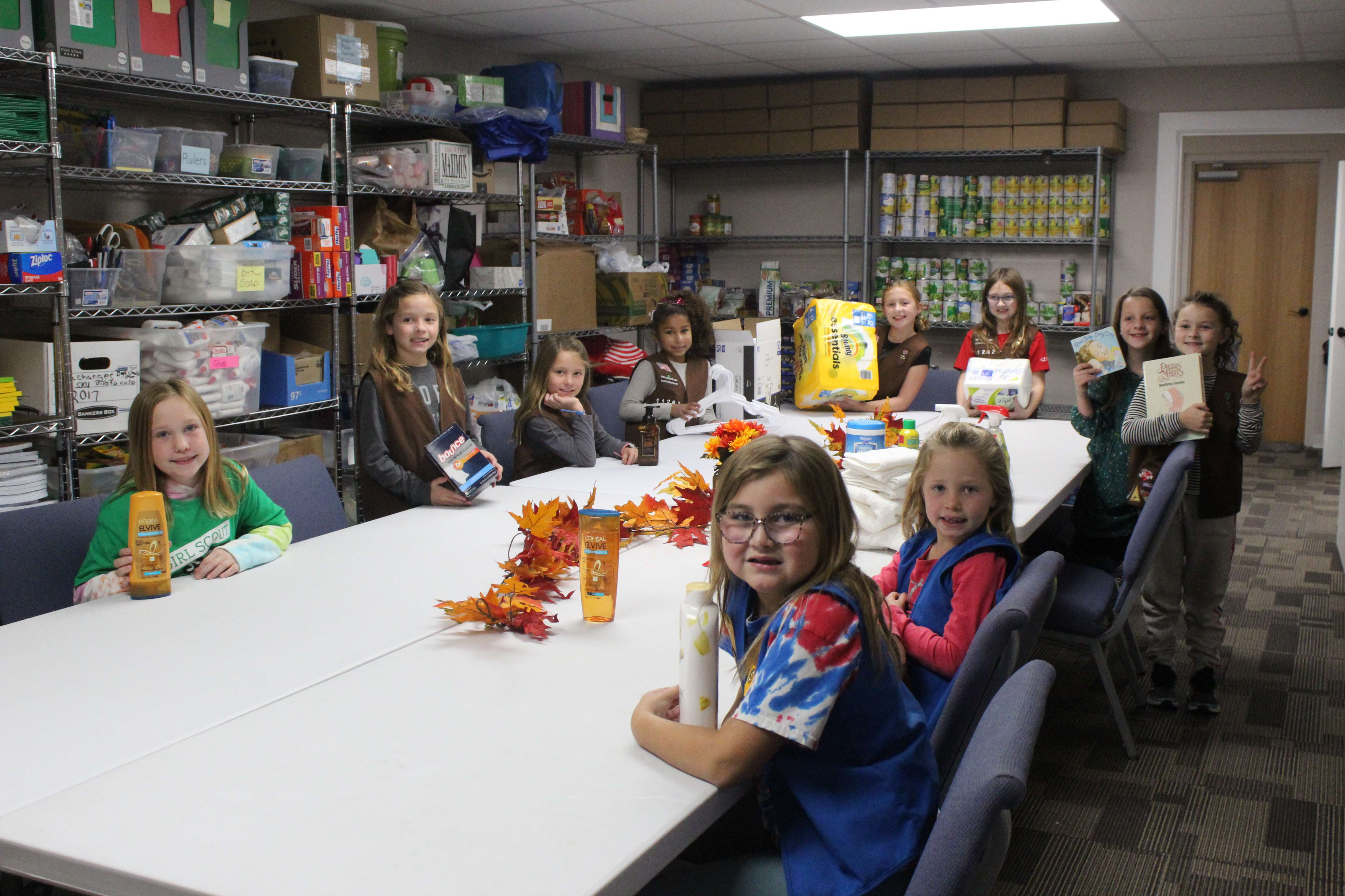 Girls representing Troop 12262 present the First Step Housing program with household items for its participants.<br>