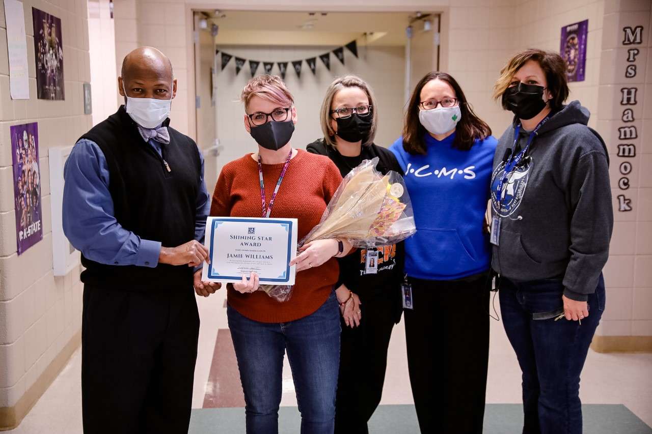 ( L-R ) Dr. Reginald Eggleston, Junction City Middle School teachers Karissa Hammock, and Nancy Campbell and Junction City Middle School Principal Heather Oentrich.