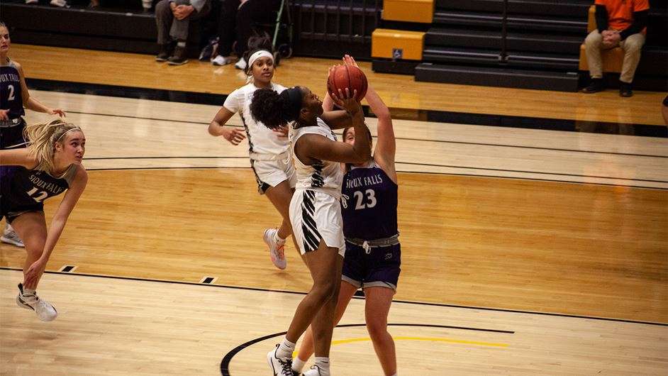 Corbyn Cunningham (left) goes up for a shot Friday against Sioux Falls. Photo by Arianne Boma.