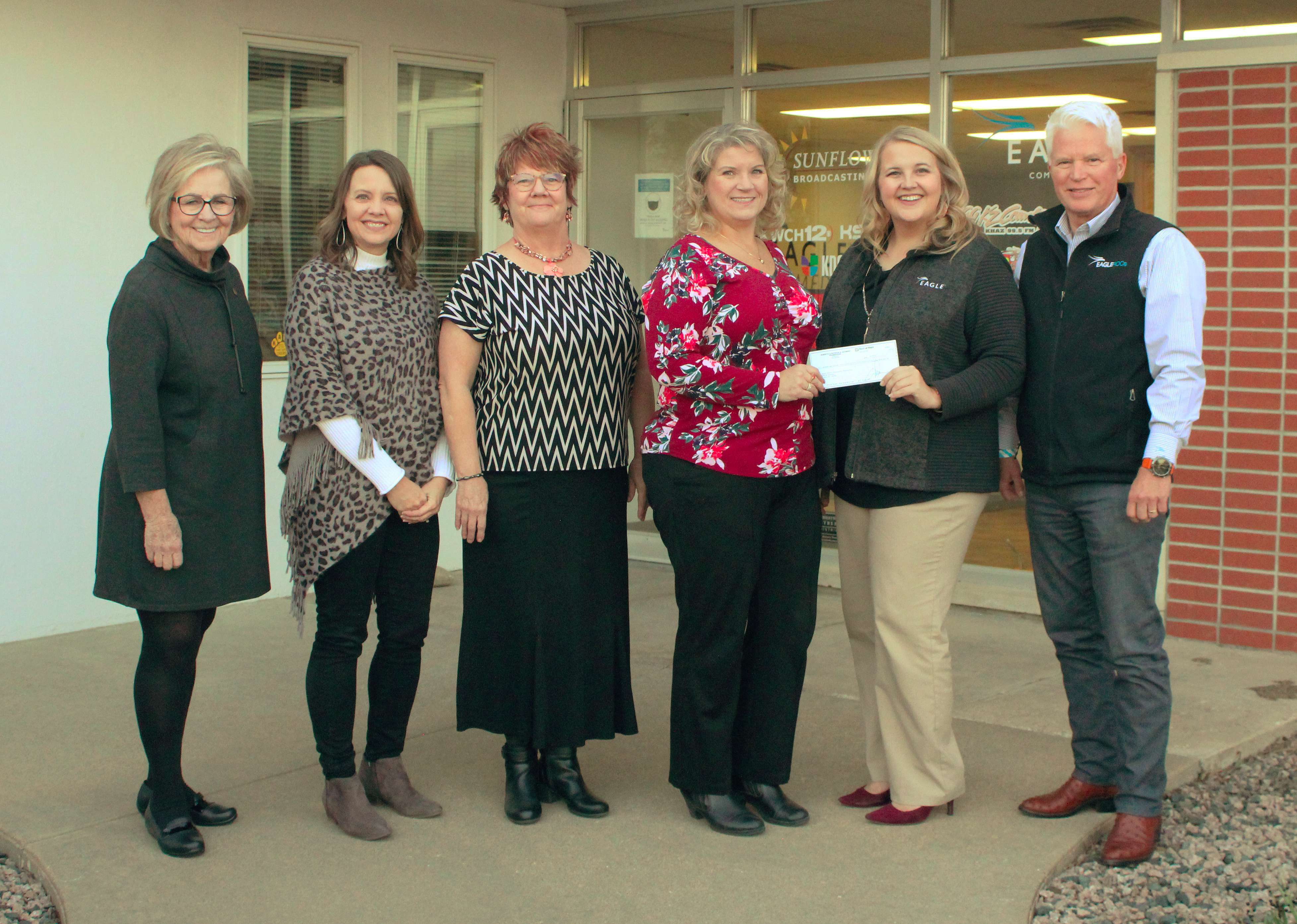 The Kansas Mission of Mercy receives a $50,000 check from the Robert E. and Patricia Schmidt Foundation. Pictured from left are Hays Mayor Sandy Jacobs; Melissa Dixon, director for the Hays Convention and Visitors Bureau; Janet Kuhn, Hays CVB; Niki Sadler, director of the Kansas Dental Charitable Foundation; and Katie Dorweiler and Gary Shorman, representing the Schmidt Foundation.<br>