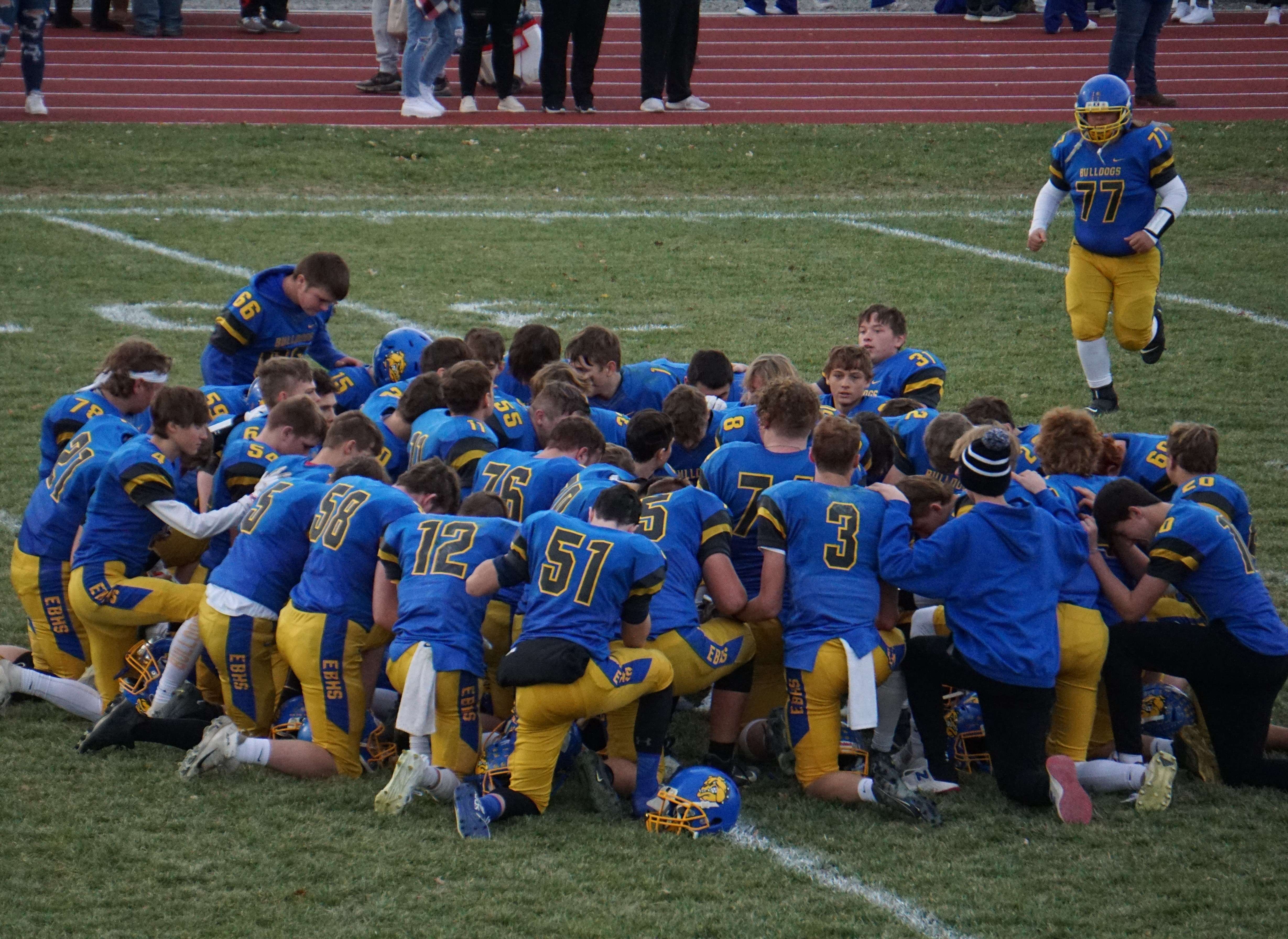 East Buchanan comes together after their 22-12 win over Hamilton is state quarterfinals Saturday. Photo by Tommy Rezac.