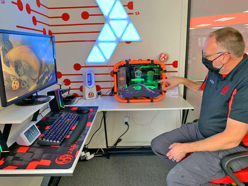 <b>JAB IT PC's Jason Bathon duscusses one of his custom built computers that includes a cooling system similar to a car's radiator system.</b>