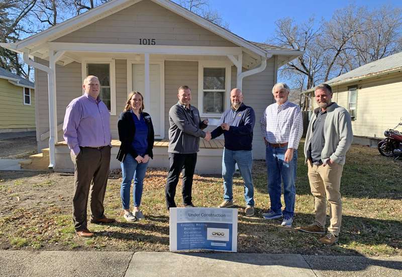 <b>Ben Waters, third from left, presents a check on behalf of The Schmidt Foundation to representatives of the&nbsp;Community Housing Development Corporation of Central Kansas Friday afternoon in front of one of the organization's houses in north Salina. Joining Waters for the check presentation were, from left, Eric Brown,&nbsp;Community Housing Development Corporation (CHDC) board member, Melinda Foster,&nbsp;CHDC board member, Lance Cochran,&nbsp;CHDC board member, Gary Hobbie, CHDC director, and Andy Houltberg,&nbsp;CHDC board member.</b> Salina Post photo