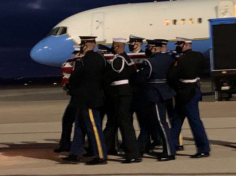 <b>Honor guard members carry the casket to the awaiting hearse.</b>