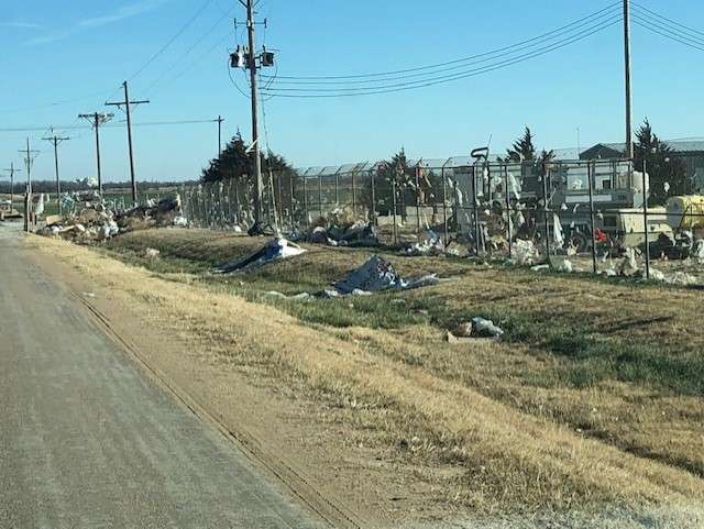 Debris sits along the fence line at the Reno County Landfill following a recent wind storm. The landfill will now close when extreme wind conditions are present.