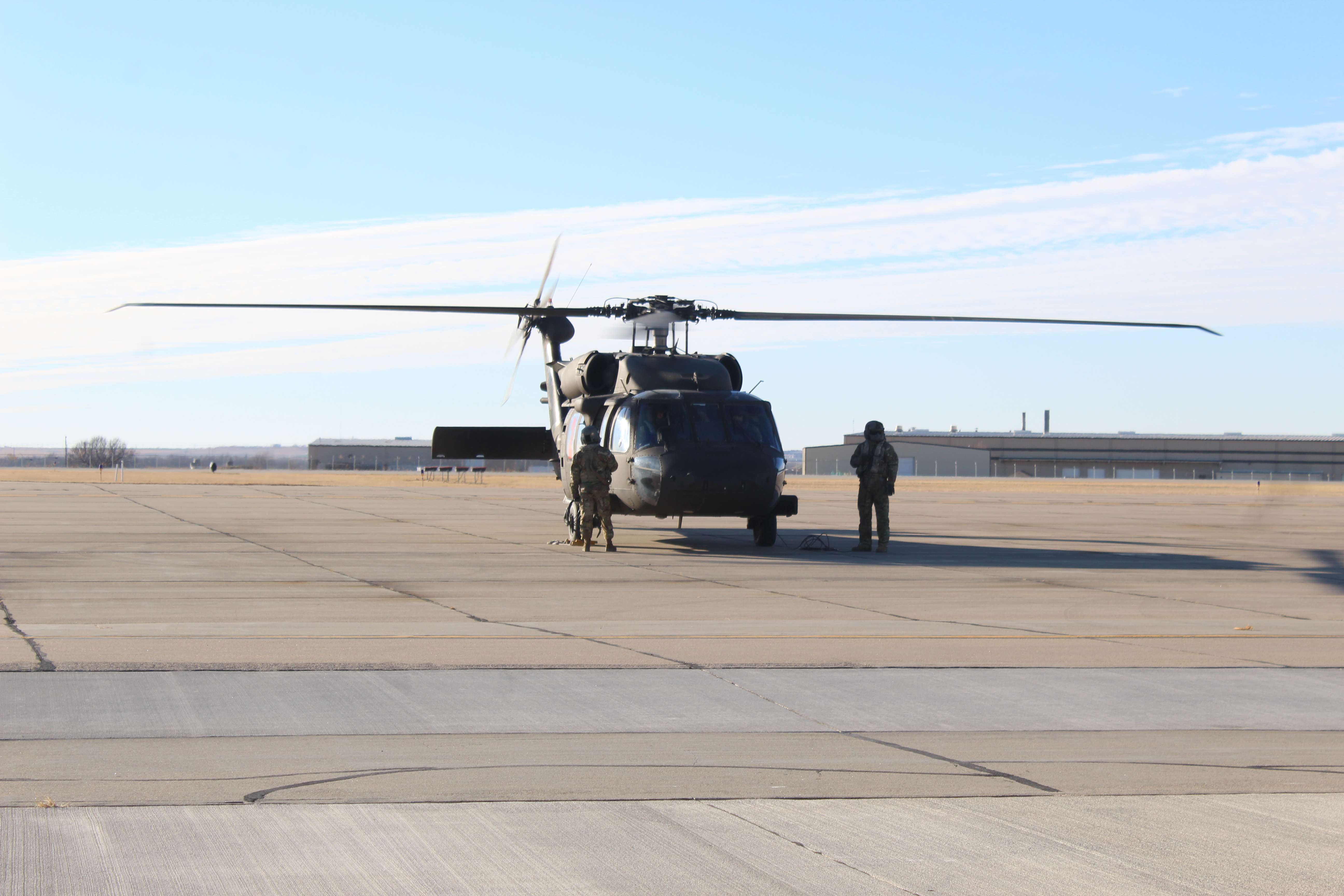A Blackhawk crew assigned to transport water to area wildfires Friday prepares to take off from Hays Regional Airport.<br>