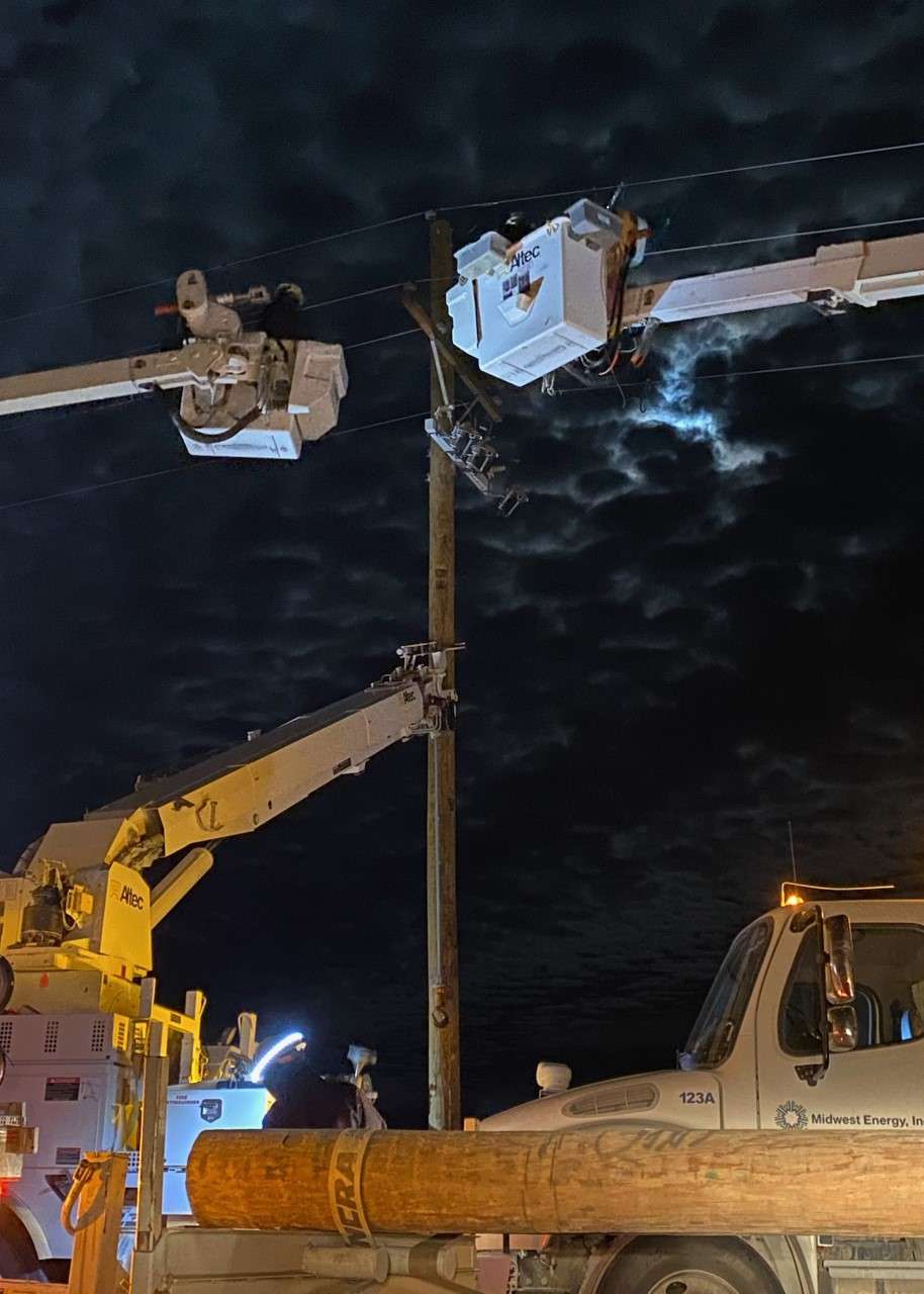 Crews from contractor Ward Electric work on Midwest Energy poles in the Fairport area on Dec. 22; the “4 corners” area of Rooks, Ellis, Osborne and Russell Counties saw severe wind and fire damage after the Dec. 15 wind event. Courtesy photo.