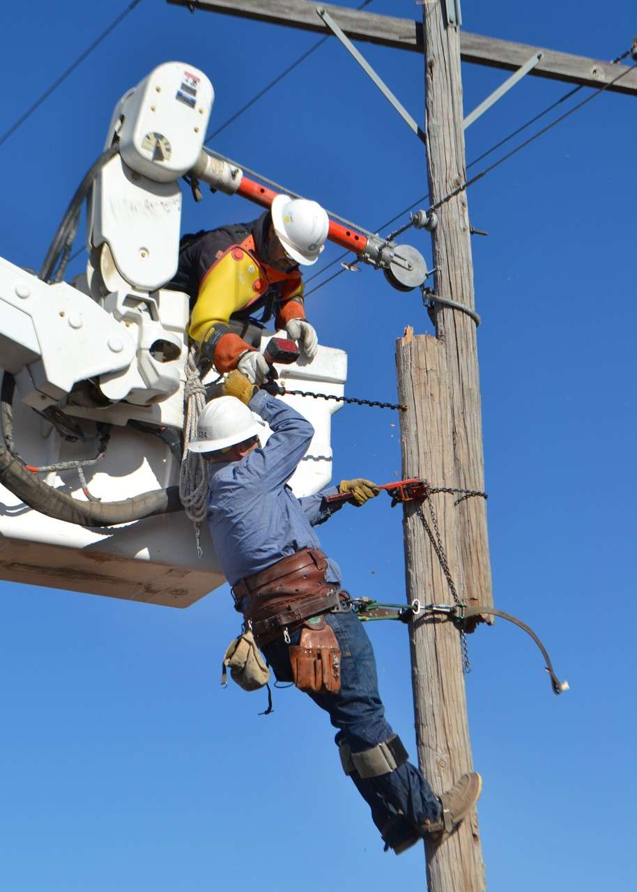 Midwest Energy linemen from Hays apply a temporary fix to a broken pole in the Pfeifer area of Ellis County on Dec. 16. Poles that can take temporary repairs allow for faster restoration of power after major events, allowing crews to come back and replace “temporary” poles at a later date. Courtesy photo.