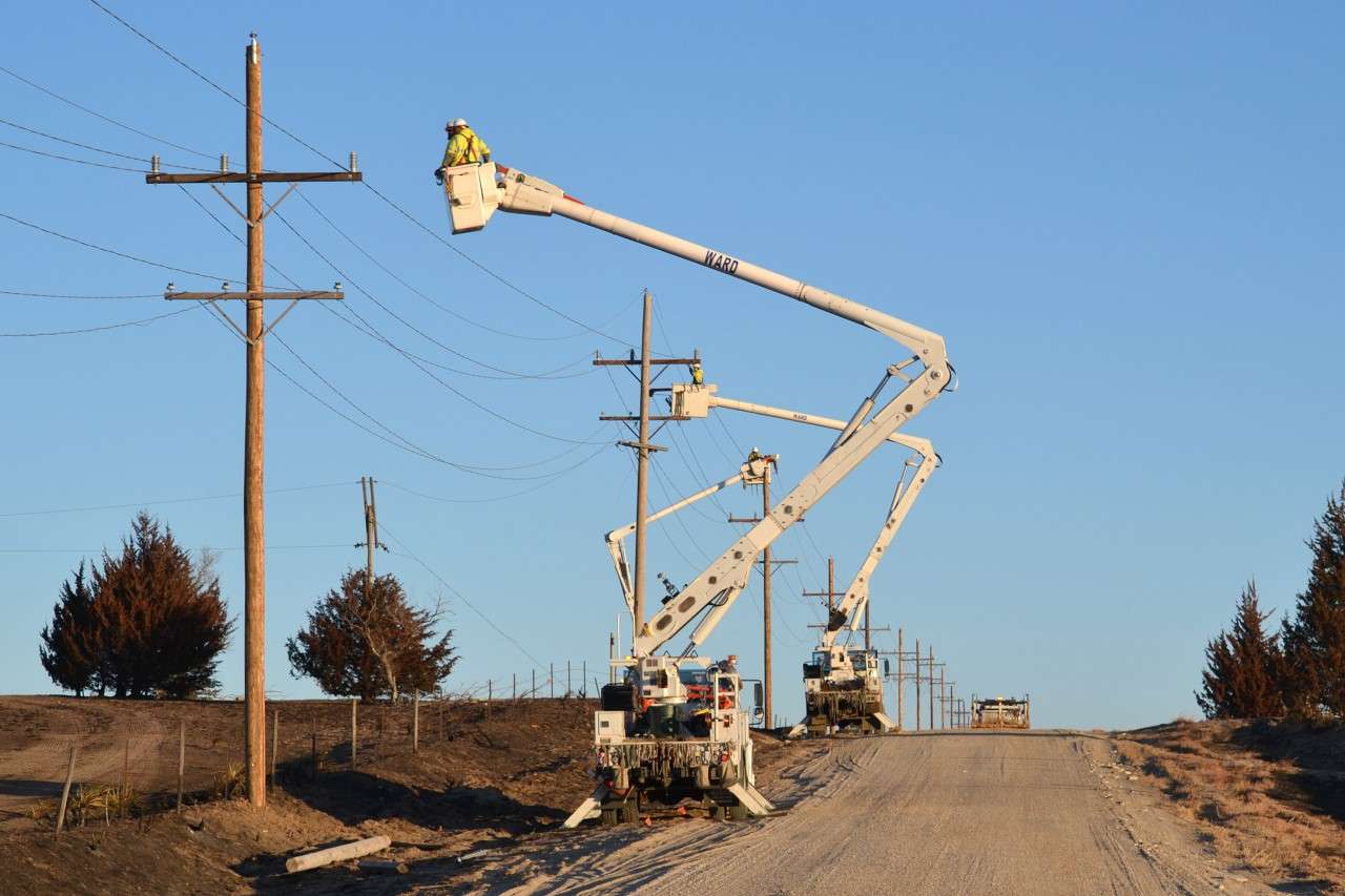 Crews from contractor Ward Electric work on Midwest Energy poles in the Fairport area on Dec. 22; the “4 corners” area of Rooks, Ellis, Osborne and Russell Counties saw severe wind and fire damage after the Dec. 15 wind event. Courtesy photo.