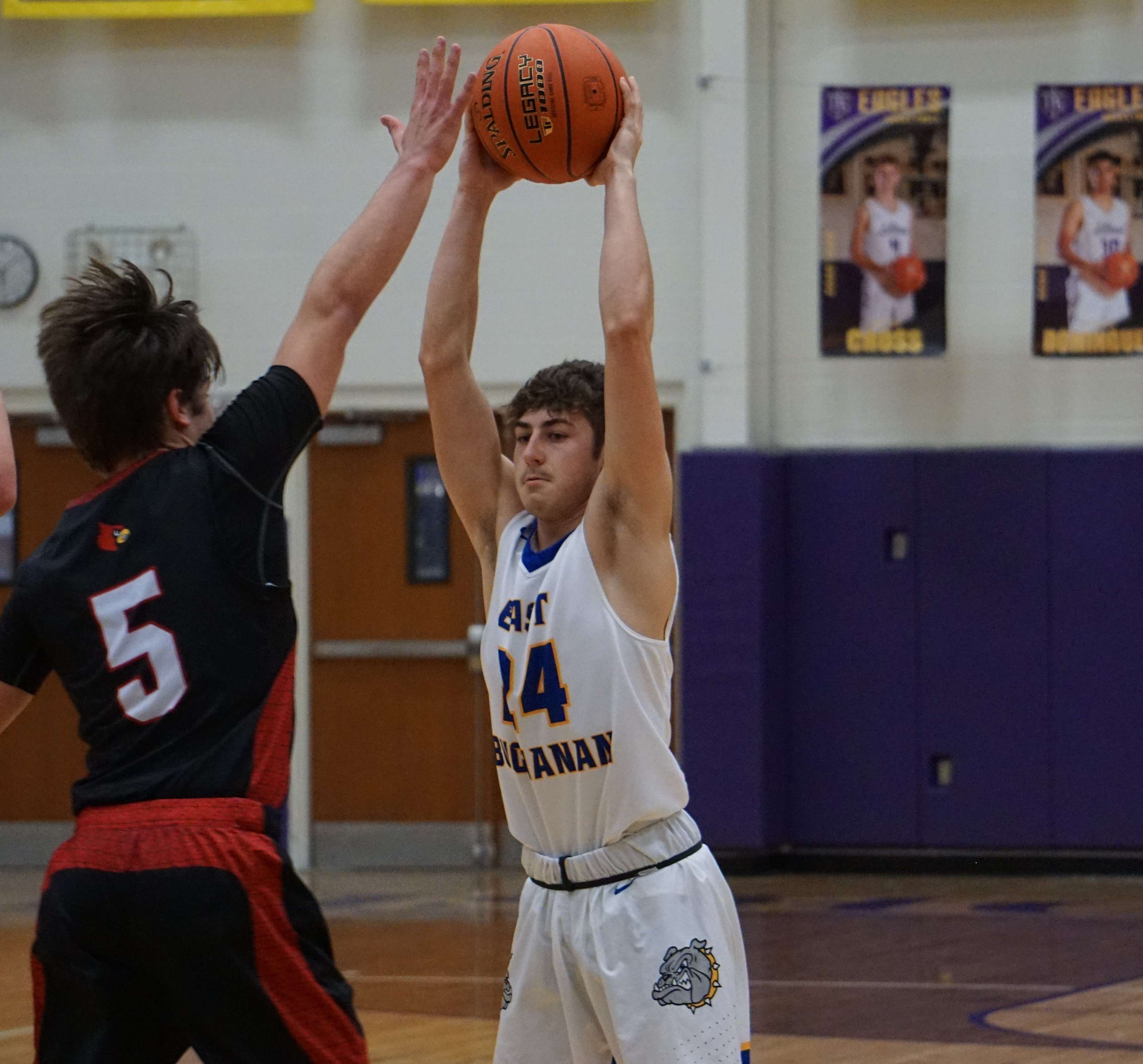 North Andrew's Braxon Linville (5) guards East Buchanan's Carson Thompson (24) on Monday. Photo by Tommy Rezac.