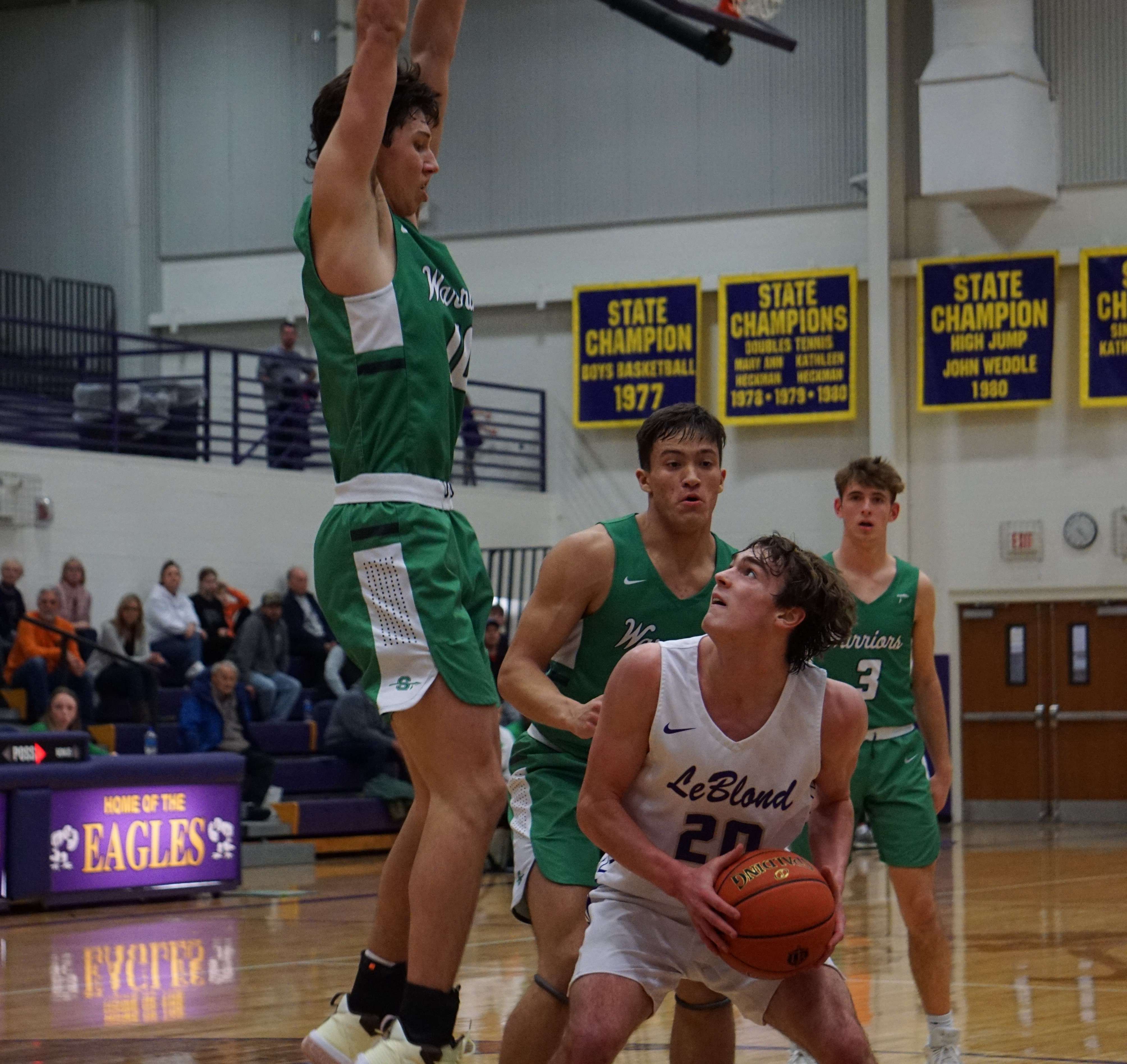 Jake Korell (20) goes up for a shot against a defender in the second half. Photo by Tommy Rezac.