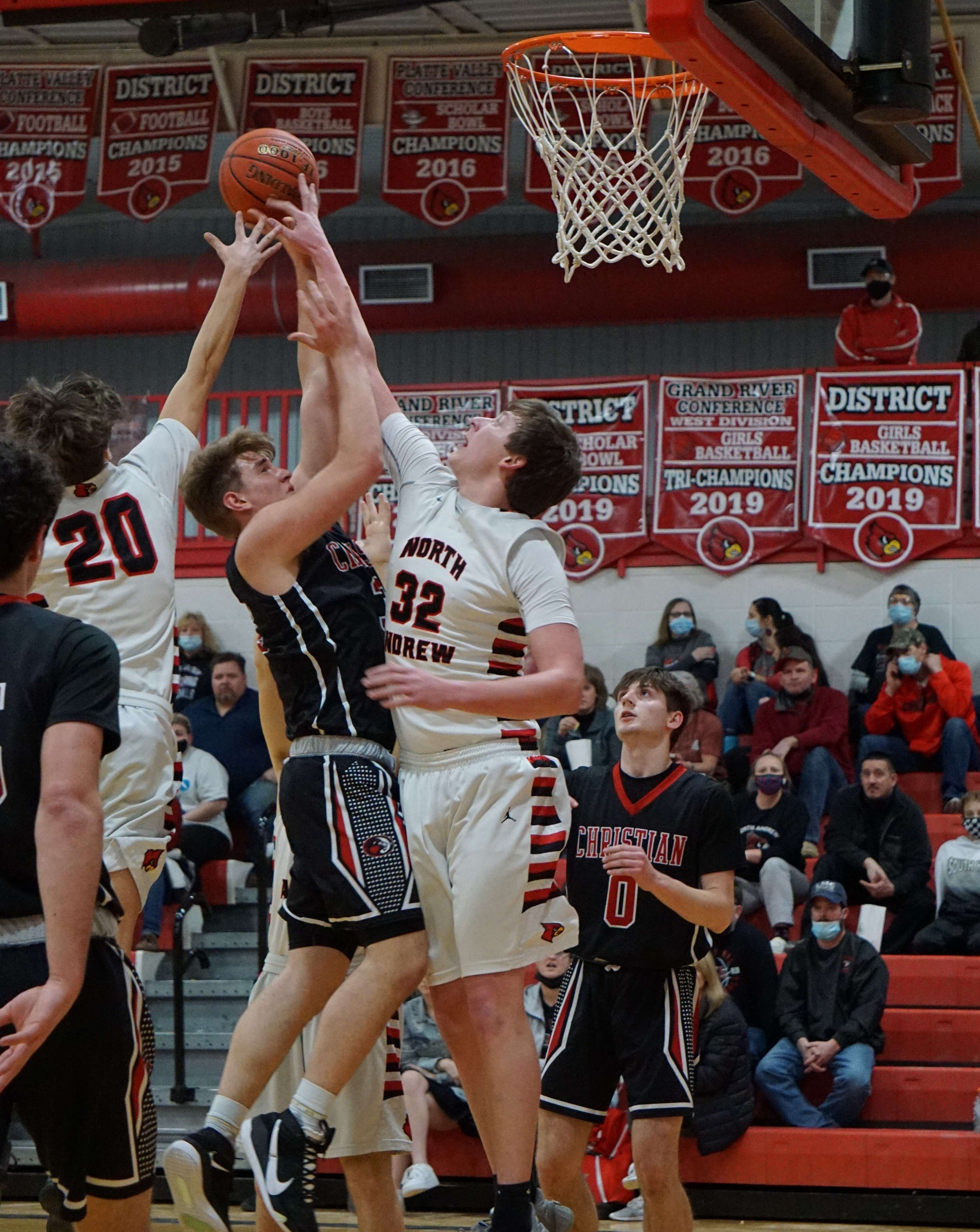 North Andrew's Owen Graham and Gunner Lawrence throw a block in the first half of the Cardinals' 76-46 win over St. Joseph Christian. Photo by Whitnee Ice.