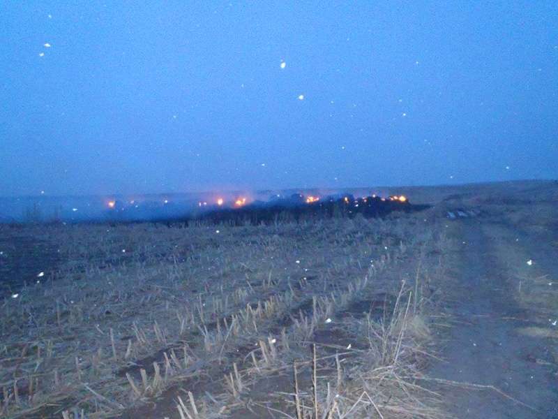 <b>The bales continue to burn as dawn breaks Saturday and a light snow falls.</b>