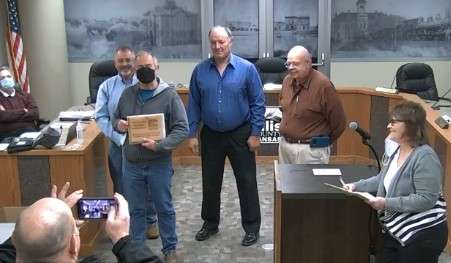 Retired Sheriff Ed Harbin poses for a picture with Ellis County commissioners marking his 40 years of service to the county. Taking the photo is the new Ellis County Sheriff Scott Braun.