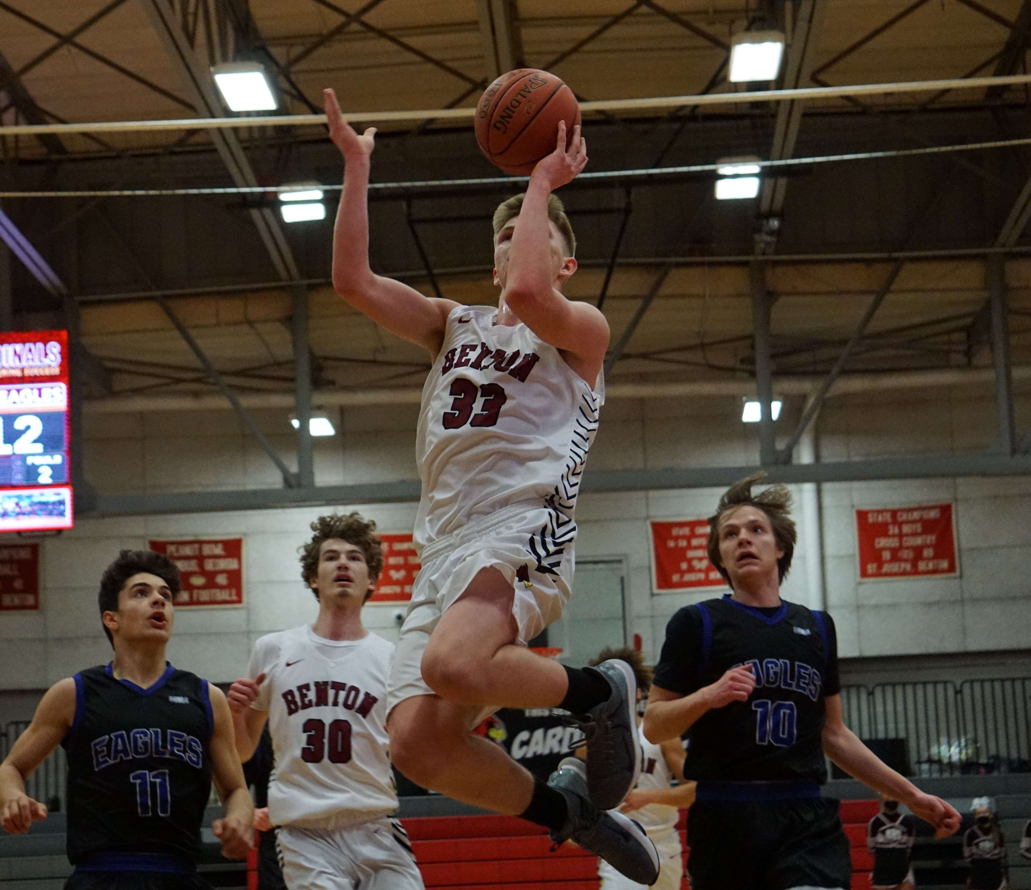 Benton's Denver Domann goes airborne on his way to a first half layup in Thursday's 50-37 loss to Bishop LeBlond on Thursday night. Photo by Tommy Rezac.