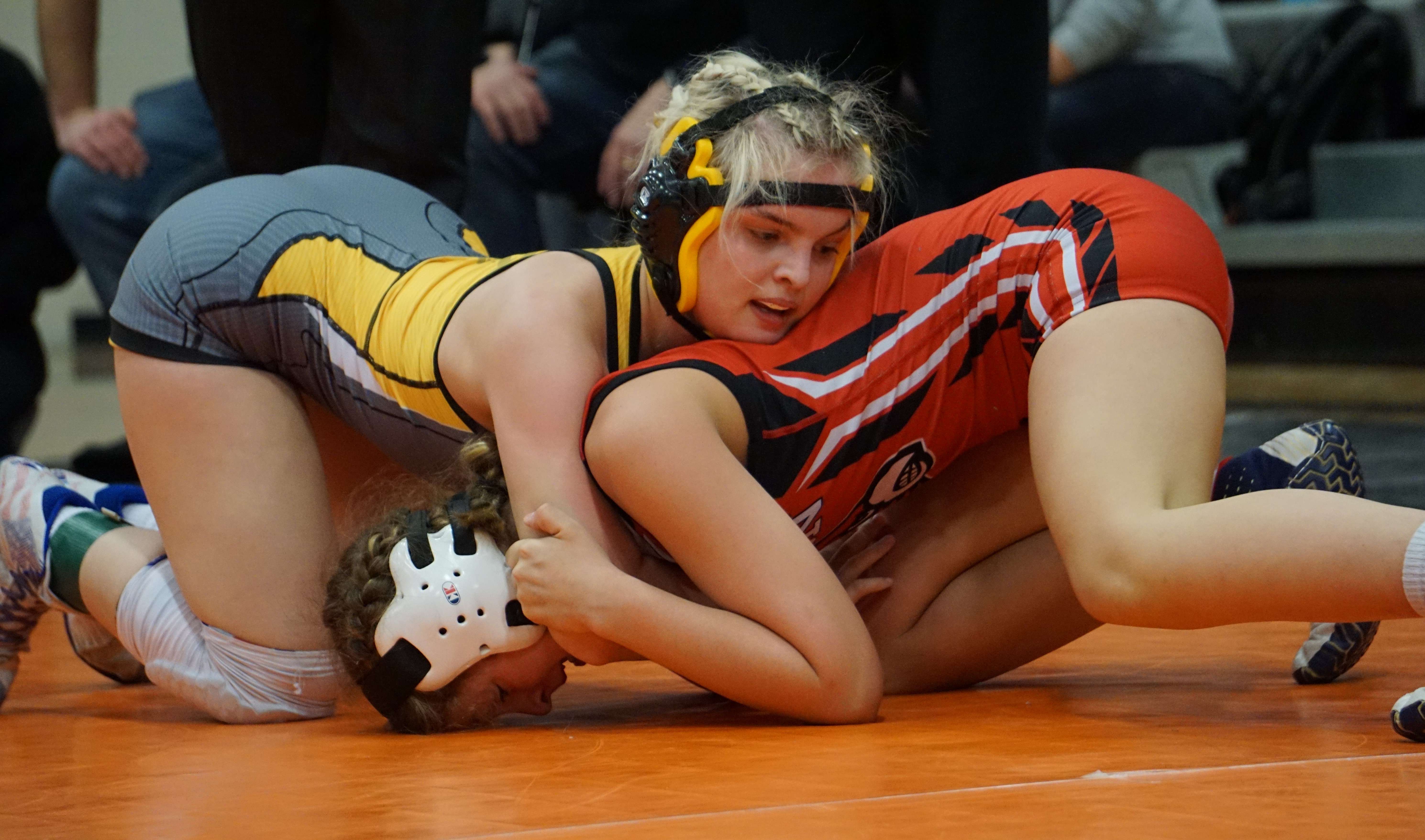 Cameron's Christina Filley (left) wrestles against Josie Bryant of Lawson in the semifinals of the 122-pound bracket in Saturday's sectional meet. Photo by Tommy Rezac.