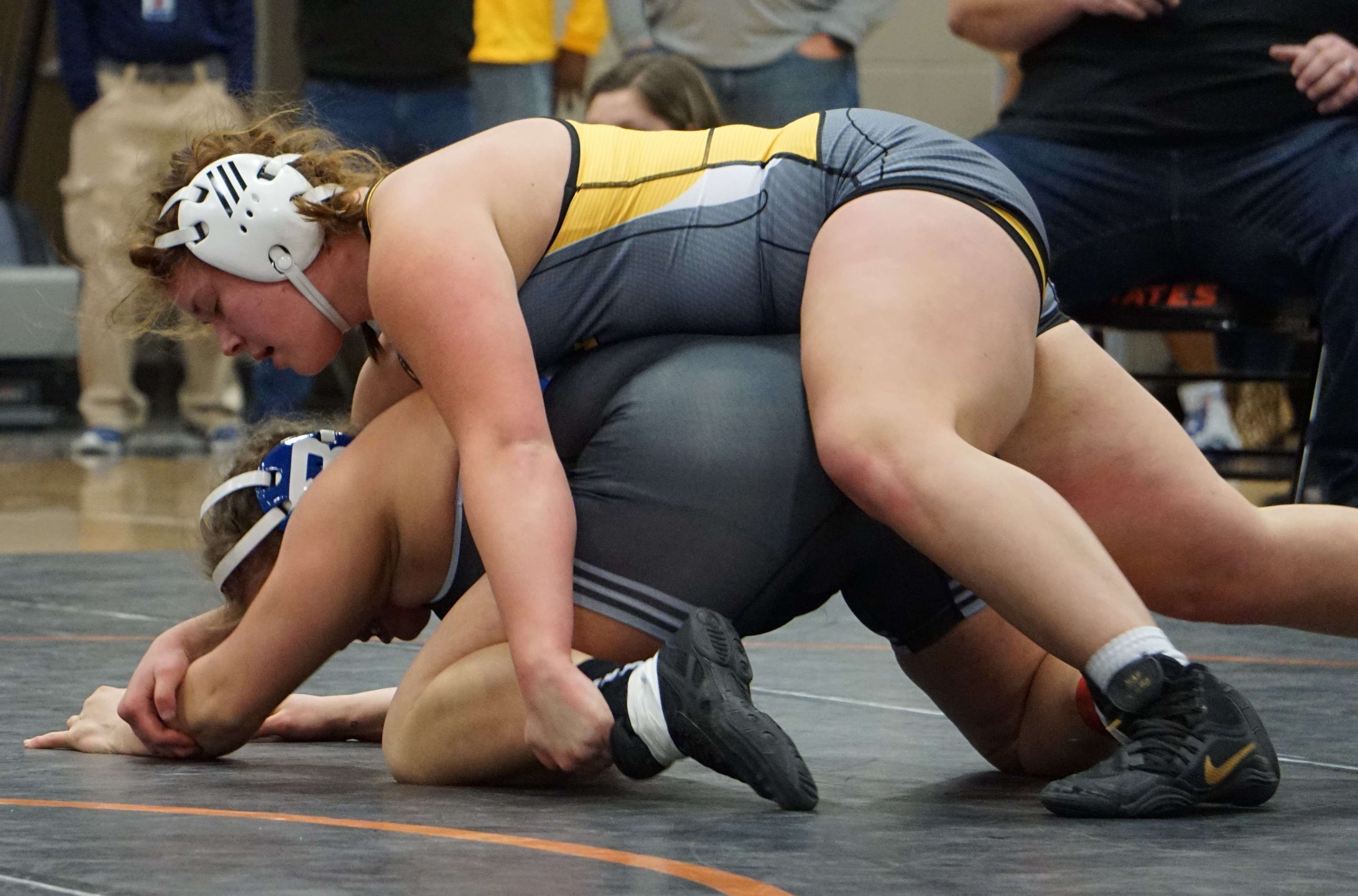 Cameron's Hollie Hedgpath (top) battles Zoey Chrisman of Brookfield in the semifinal match of the 174-pound bracket during Saturday's sectional meet at Platte County High School. Photo by Tommy Rezac.