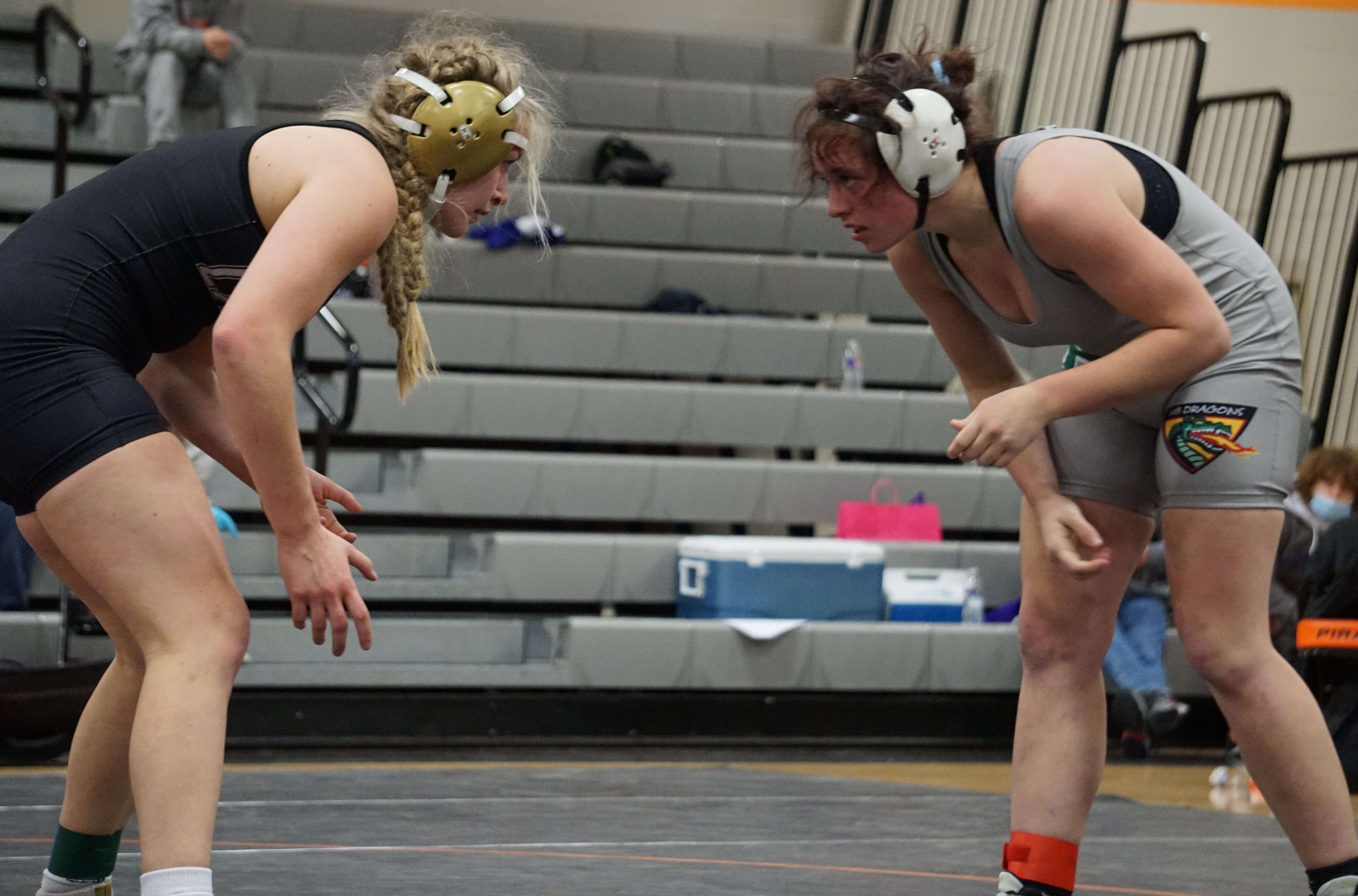 Lathrop's Josie Wright (left) squares up Mid-Buchanan's Layson Hafley in the semifinal match of the 143-pound bracket during Saturday's sectional meet at Platte County High School. Photo by Tommy Rezac.