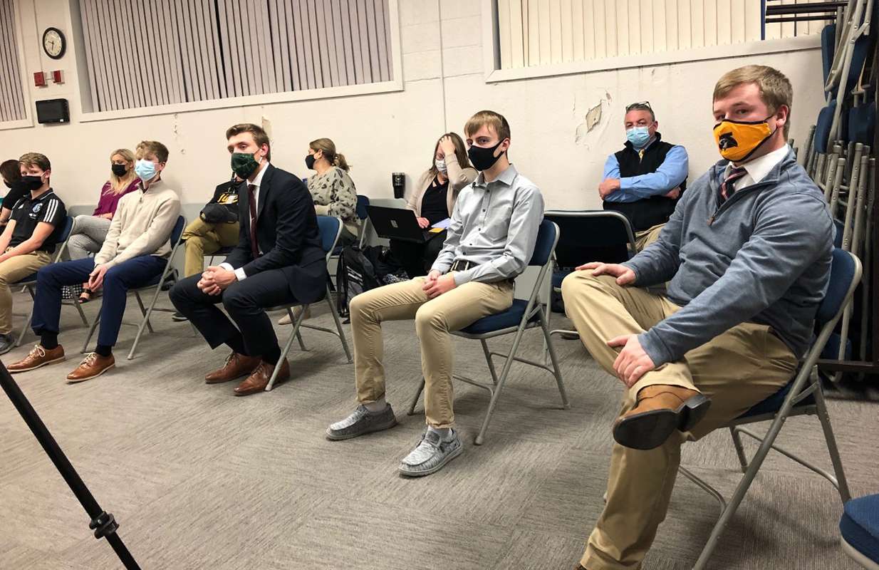HHS soccer athletes and assistant coaches listen to the Hays USD 489 school board consider acceptance of donations for two new soccer fields on Monday night.