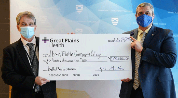 <i>Mel McNea, Great Plains Health chief executive officer, presents a check for $500,000 to MPCC President Ryan Purdy on Wednesday. The commitment from GPH will be used to expand the college’s Health and Science Center.</i>