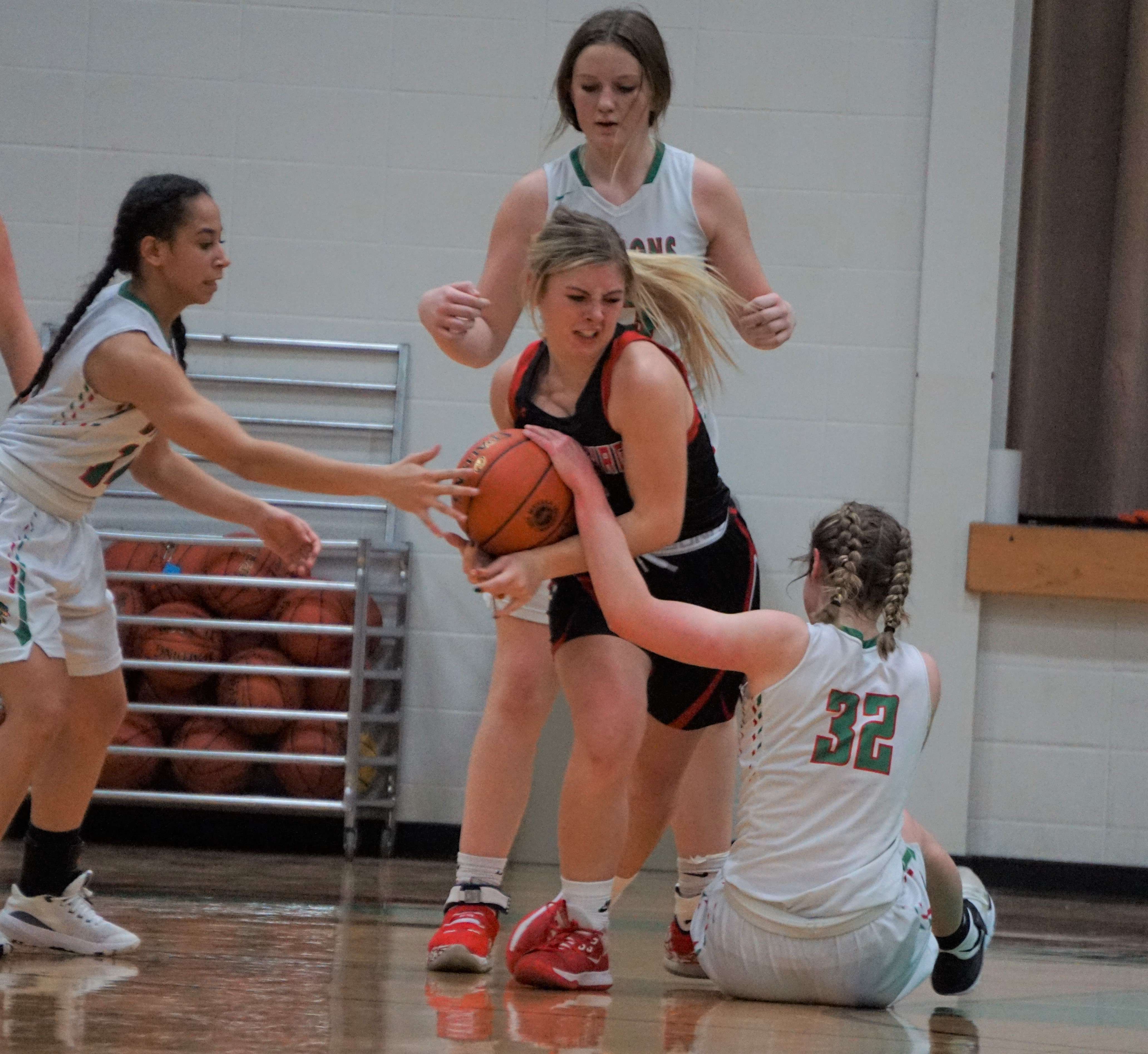 Plattsburg's Mae Hadley tries to fend off three Mid-Buchanan defenders in Friday night's Class 2 District 15 championship at Mid-Buchanan High School. Photo by Tommy Rezac.